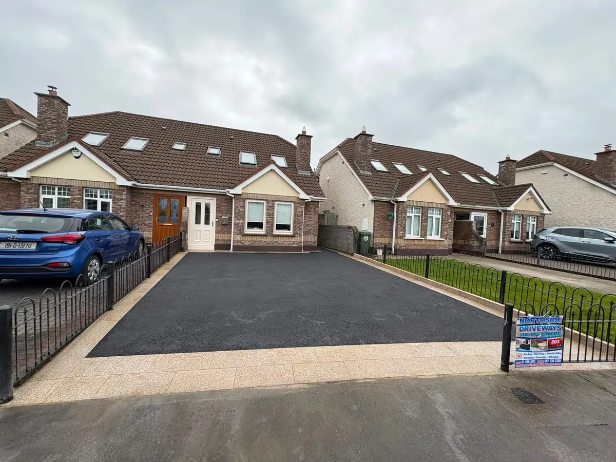 Wide black tarmac driveway with kerbed edging at a Dublin home